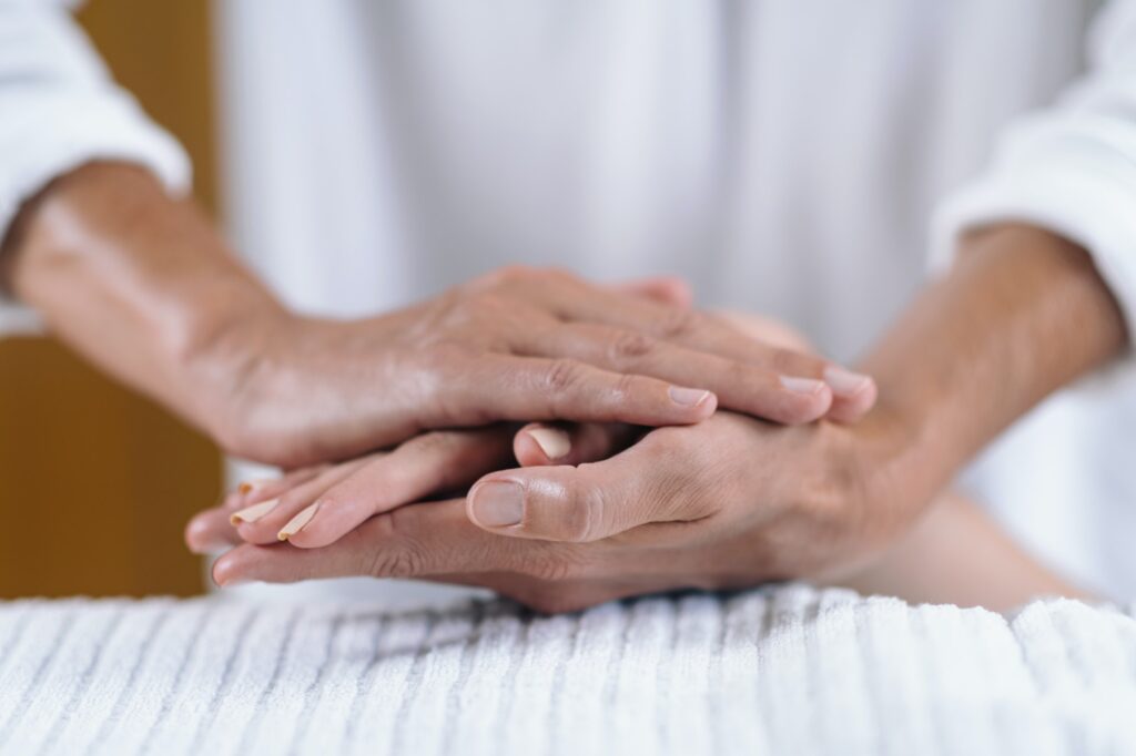 Holding Hands At Reiki Healing Treatment